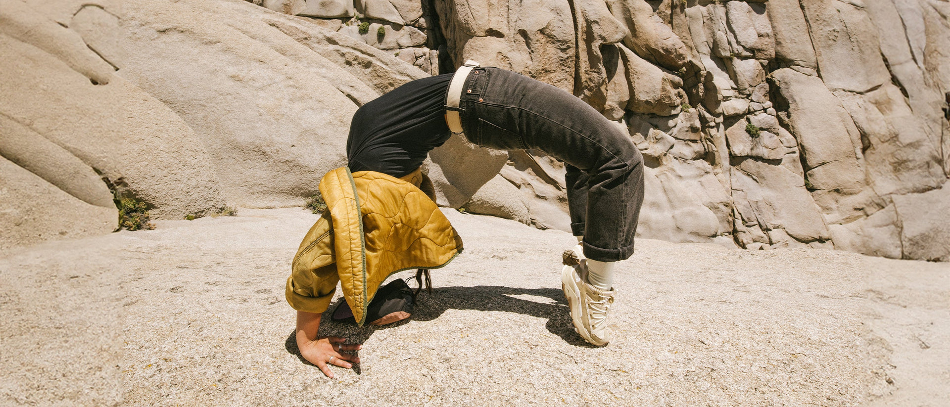 woman doing acrobatic trick wearing belt and yellow jacket