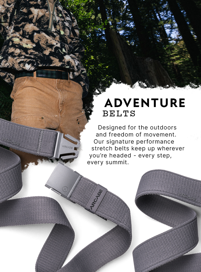A person wearing tan shorts and a belt stands in a forest. Text reads: Arcade Belts—designed for the outdoors and freedom of movement. Signature elastic stretch belt with a plastic buckle keeps up wherever you’re headed. Two gray belts are shown below.