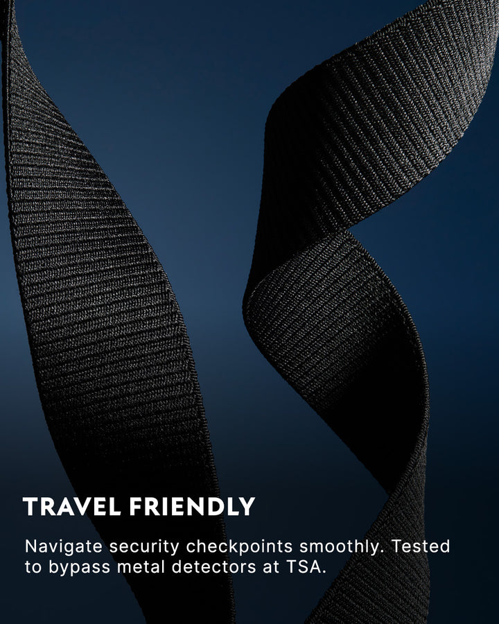 A close-up of a black, textured strap with a twist against a dark blue background. Text reads: Travel Friendly. Navigate security checkpoints smoothly. Tested to bypass metal detectors at TSA.