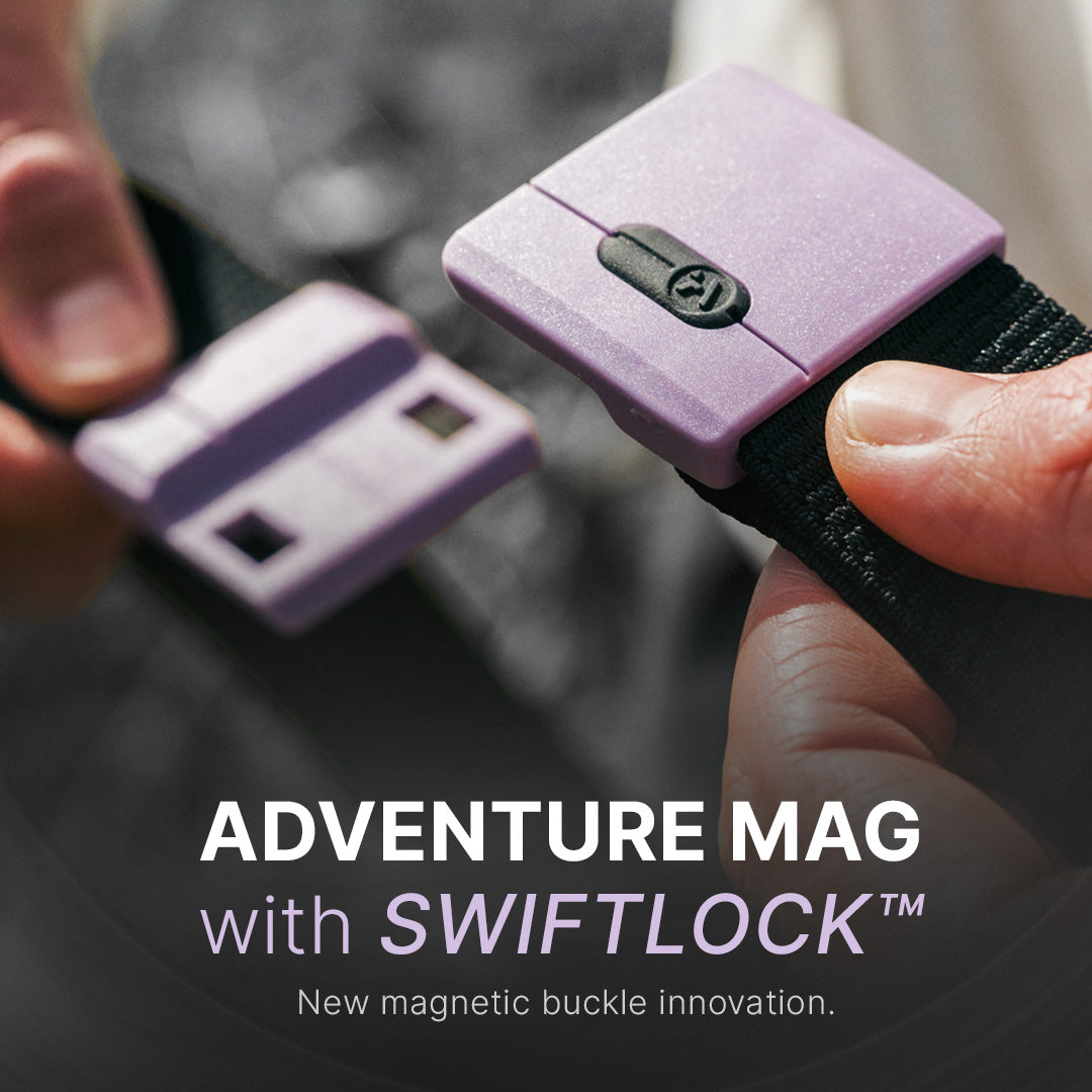Close-up of hands holding a black strap with a purple magnetic buckle, shown being connected. Text reads: “ADVENTURE MAG with SWIFTLOCK™. New magnetic buckle innovation.”.