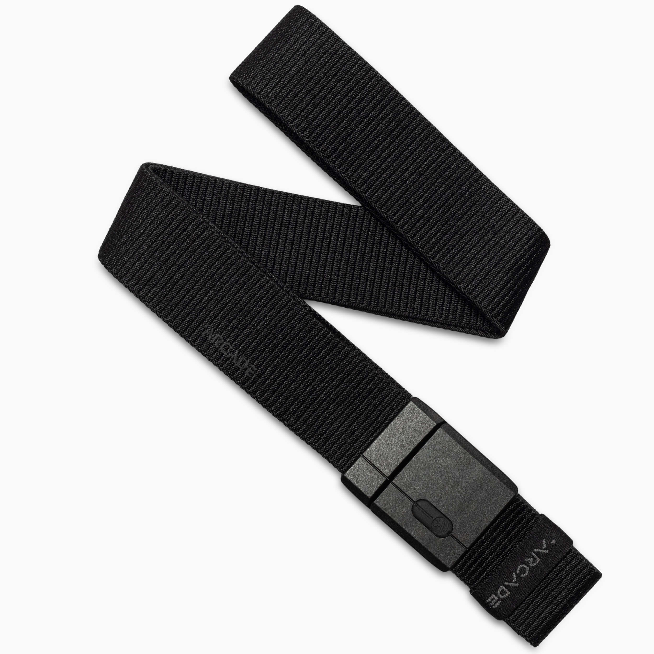 A black nylon belt with a rectangular, matte black buckle is displayed diagonally on a white background. The belt is slightly coiled at one end and has a textured, ribbed appearance.