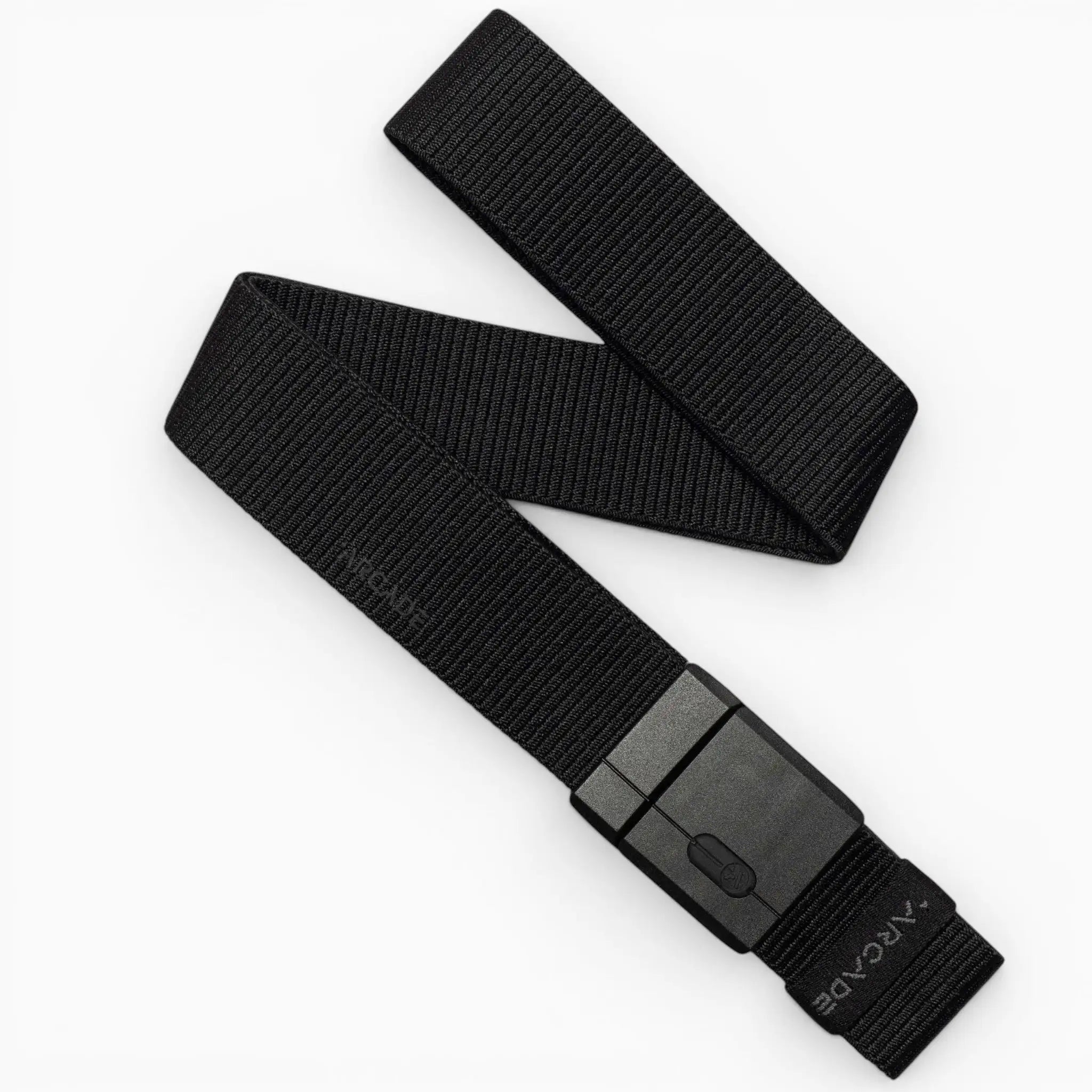 A black Mag Kit II woven nylon stretch belt by Arcade Belts, featuring a rectangular black plastic buckle, is displayed on a white background. The belt is partially folded, showcasing its flexible texture and modern minimalist design that exemplifies the adventurous spirit of Arcade Belts.