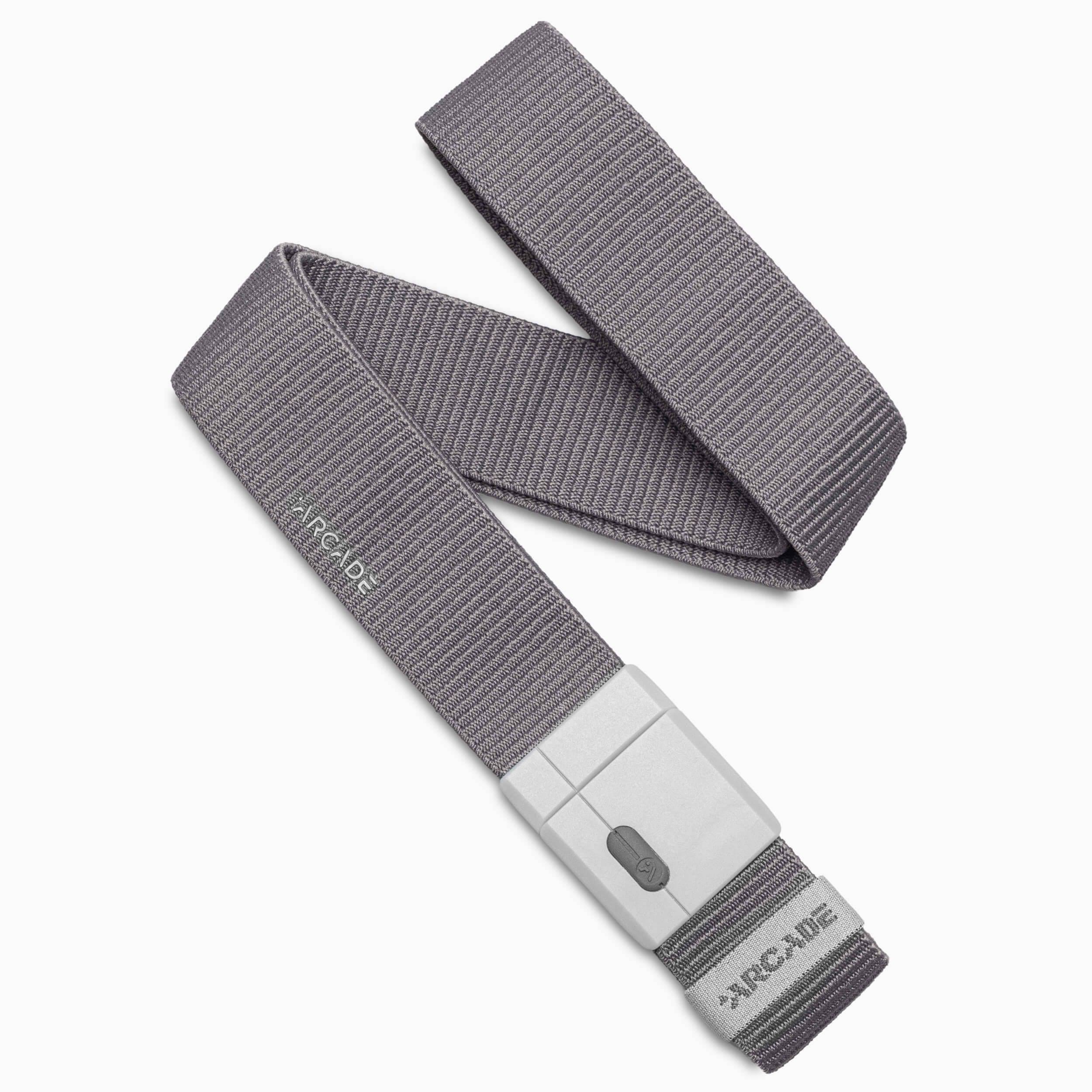 An Aero Mag belt from Arcade Belts, made of gray woven fabric and featuring a rectangular gray plastic buckle, is coiled on a white background. The brand name Arcade Belts is visible on both the belt and the durable buckle, designed for long-lasting wear.