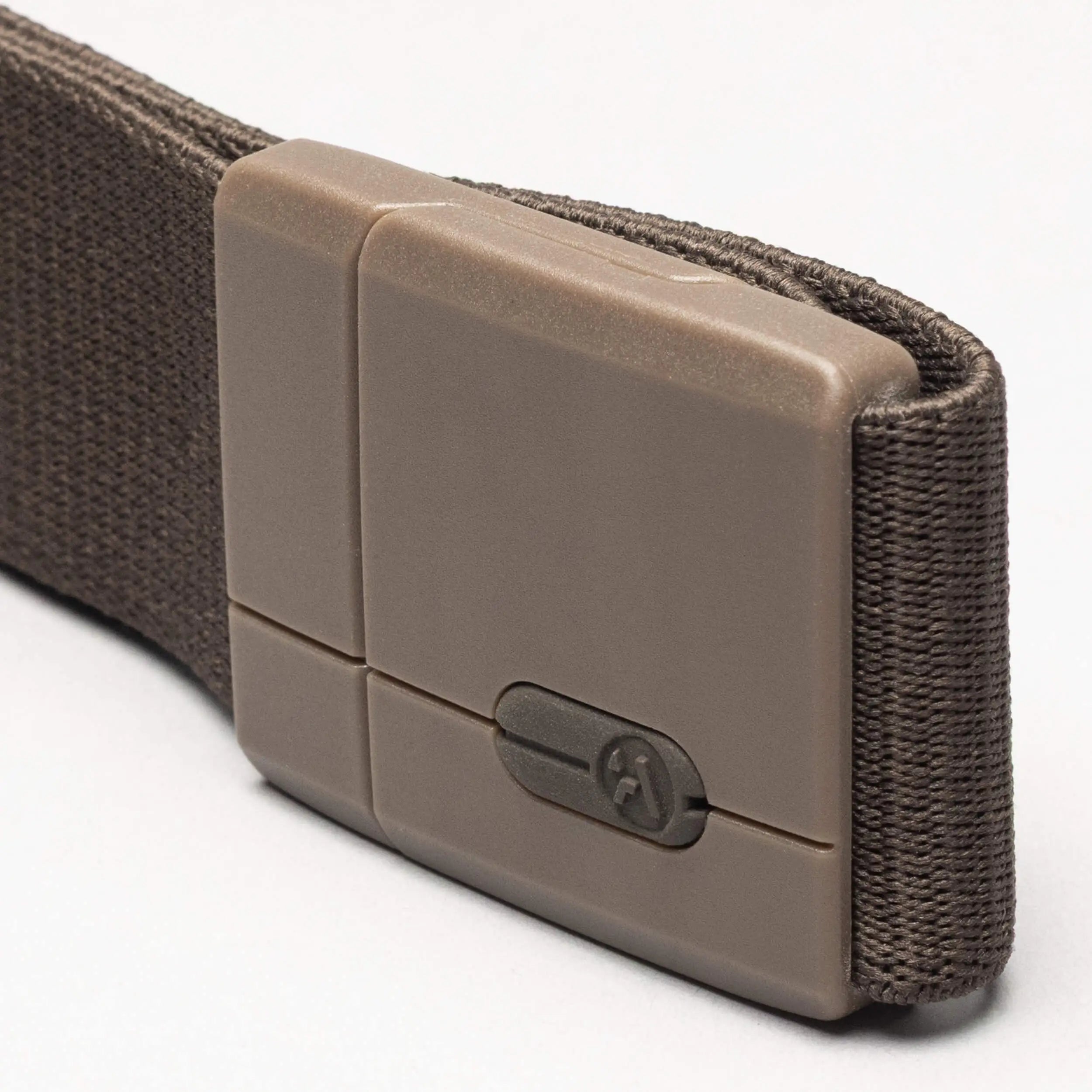 A close-up of the Arcade Belts Aero: a brown nylon belt with a rectangular tan plastic tension lock buckle featuring a small screw in the center.