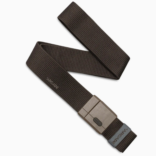 The Arcade Belts Mag Kit is a dark brown stretch fabric belt with durable textured webbing, a rectangular matte-finish SwiftLock buckle, and a stitched brand label near the end.