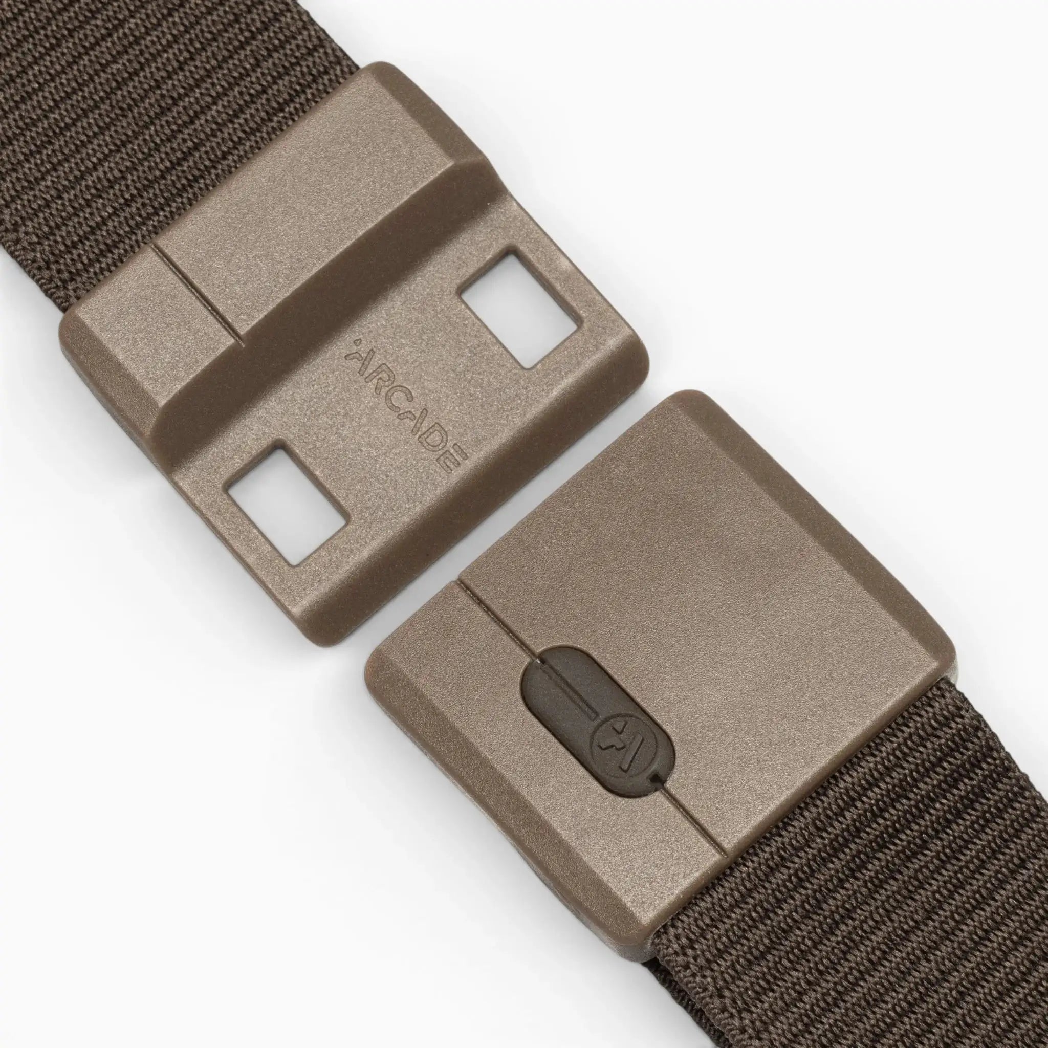 A close-up of the Aero Mag, a brown plastic belt buckle by Arcade Belts featuring a sliding tension lock mechanism, attached to a textured brown fabric strap. The durable buckle is partially opened, displaying the Arcade logo on one side.