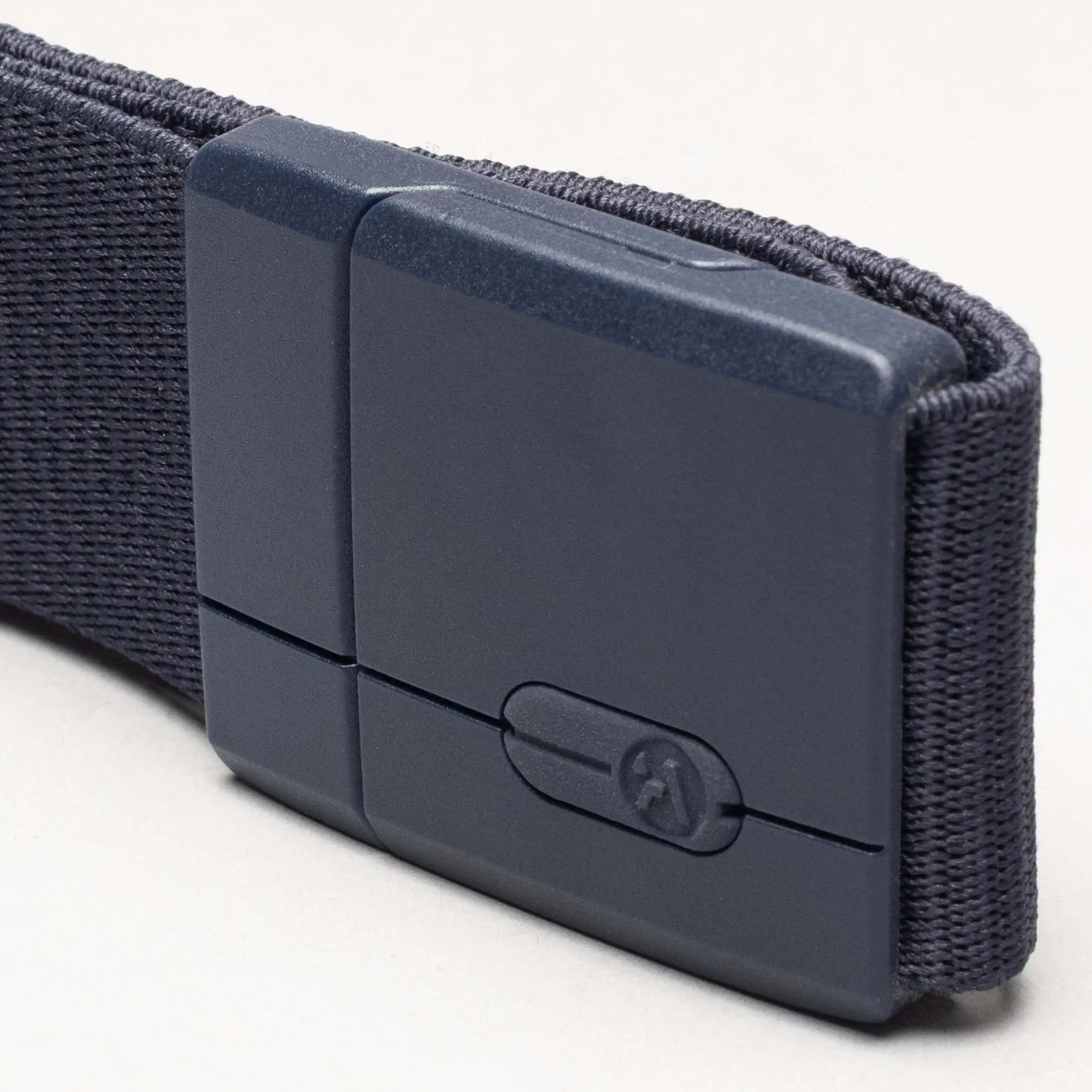 A close-up of the Aero Mag by Arcade Belts—a dark gray fabric belt featuring a durable buckle and matching rectangular plastic clasp—set against a light background.