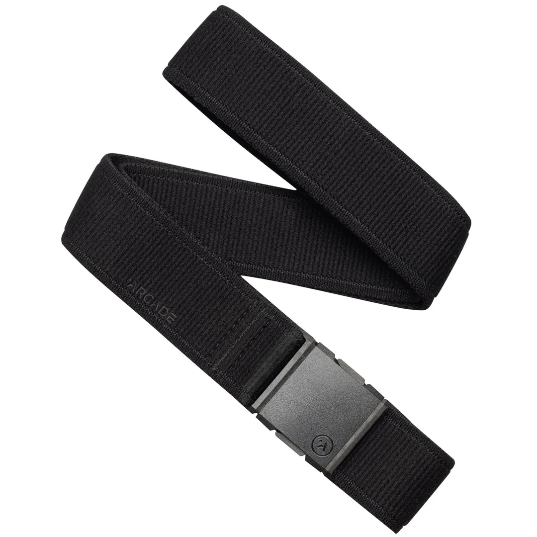 The black Atlas belt by Arcade Belts features a fabric strap, a rectangular black plastic buckle, and subtle ARCADE embossing near the buckle, making it a stylish and practical choice for travel.