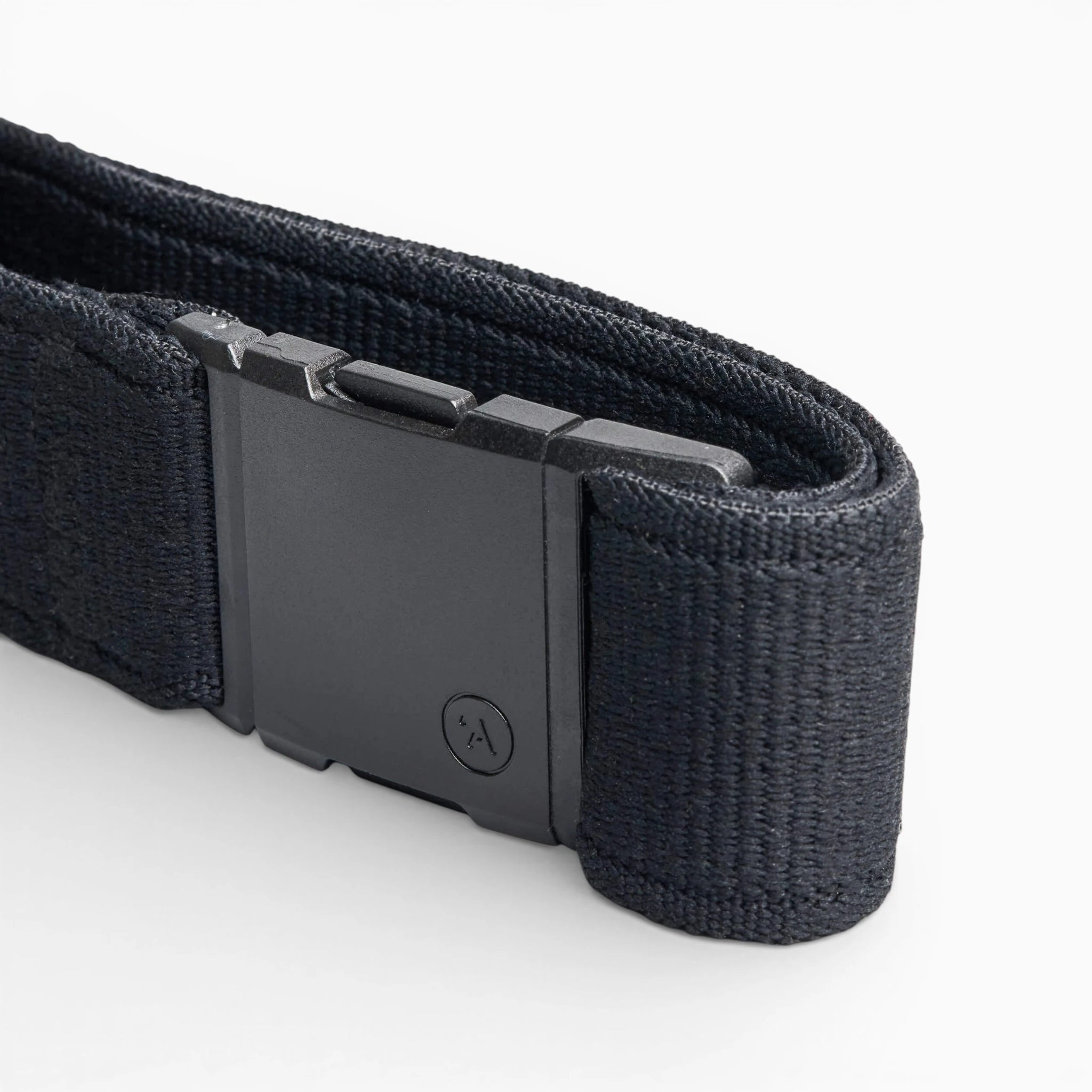 A close-up of the Arcade Belts Atlas, a black elastic stretch belt with a rectangular plastic buckle featuring a subtle logo, displayed on a white background. The webbing texture is clearly visible.