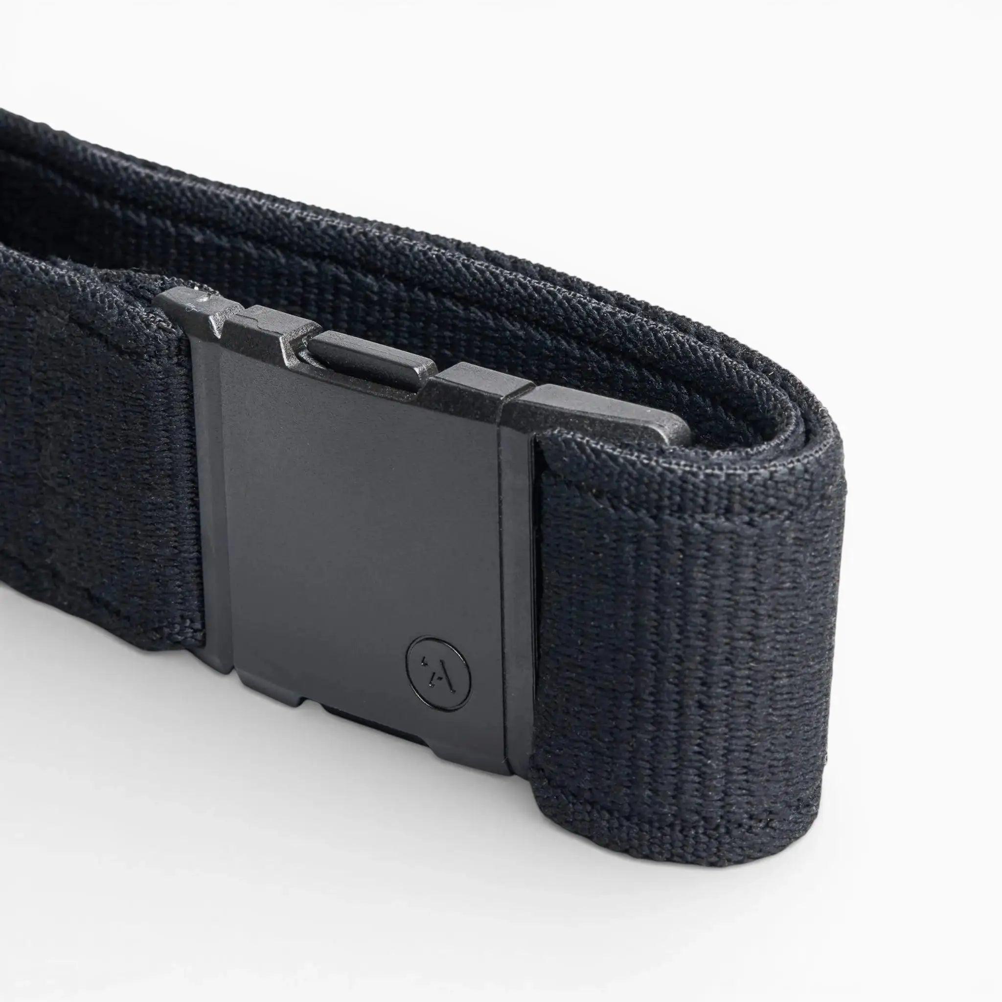 A close-up of the Arcade Belts Atlas, a black elastic stretch belt with a rectangular plastic buckle featuring a subtle logo, displayed on a white background. The webbing texture is clearly visible.