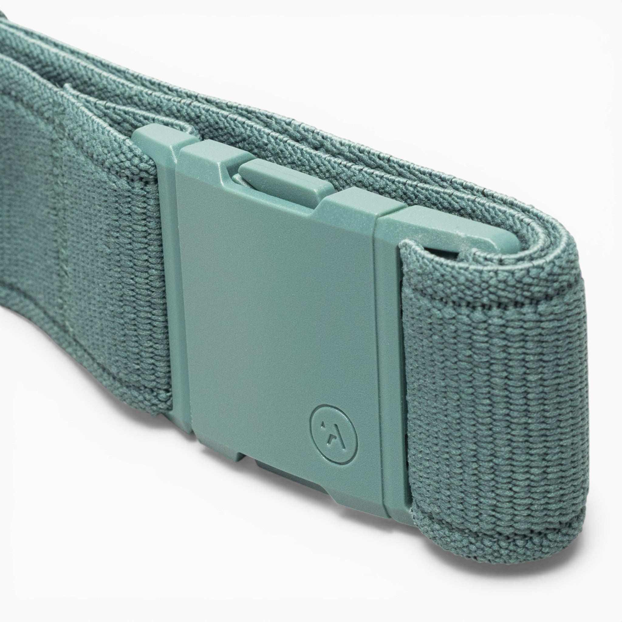 A close-up of a teal Atlas performance stretch belt from Arcade Belts, featuring a matching rectangular A2 buckle and neatly rolled for display.