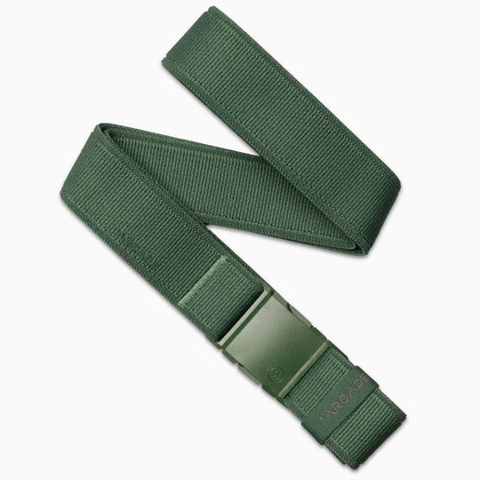 The Atlas by Arcade Belts is a green, low-profile stretch webbing belt with a plastic buckle, subtle texture, and ARCADE branding near the buckle. Partially coiled and laid flat on a white background.