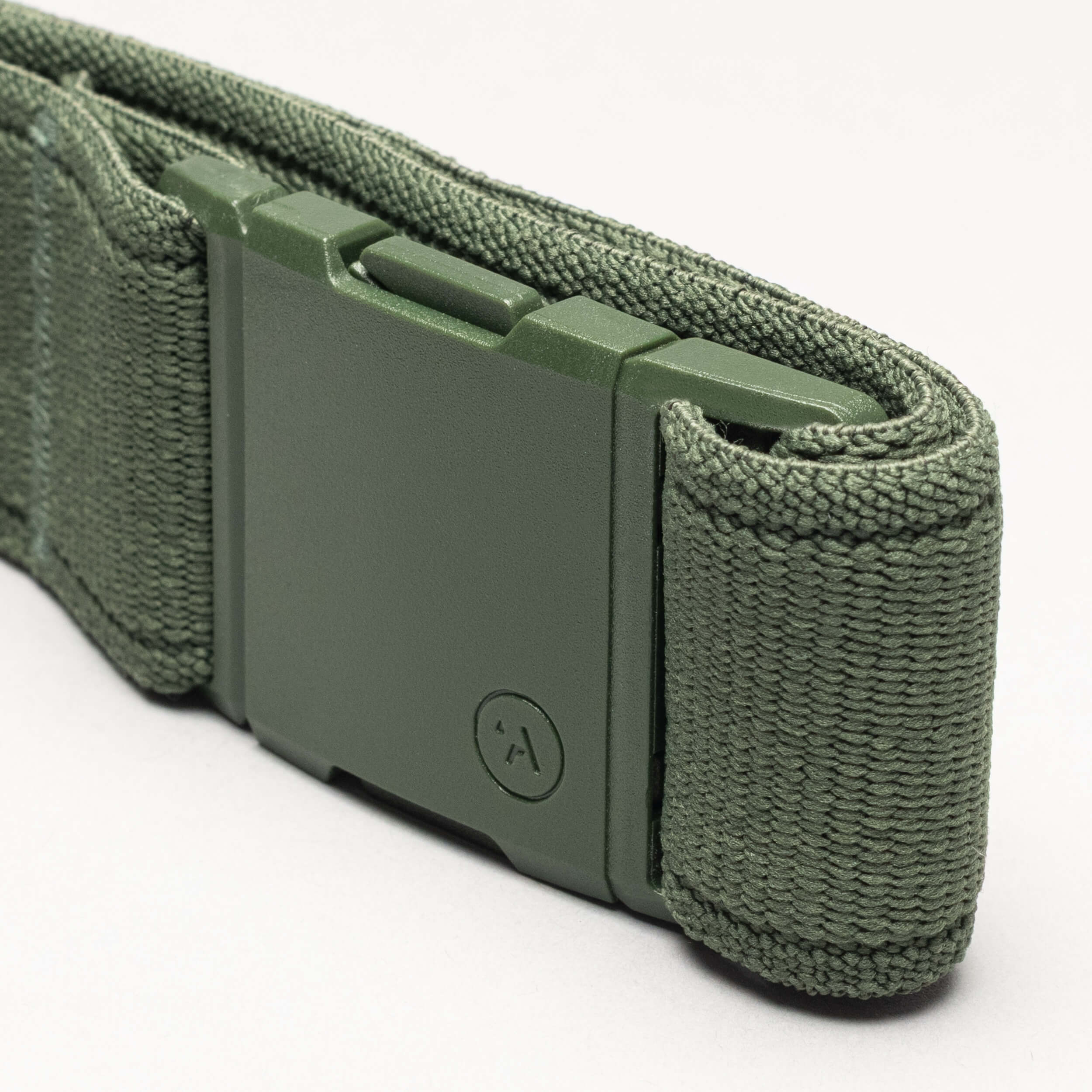 Close-up of the Atlas adventure belt by Arcade Belts in olive green, featuring a matte green A2 buckle and a small embossed circular logo on the end, set against a plain light background.