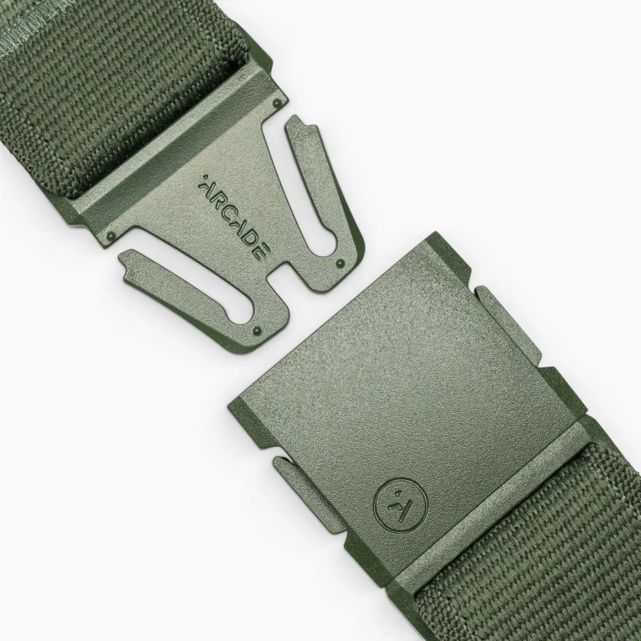 Close-up of the Atlas belt by Arcade Belts in green, featuring a woven strap and partially unclasped plastic A2 buckle. The buckle displays "ARCADE" on one side and a small logo on the other, set against a light neutral background.