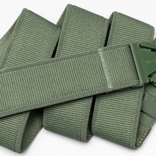 A close-up of an olive green Atlas performance stretch belt by Arcade Belts, featuring a matching green A2 buckle and the brand name embossed on the belt.