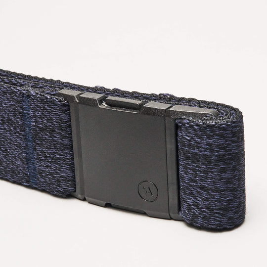 A close-up of the Atlas Low Profile Belt by Arcade Belts in navy blue, showcasing stretch webbing and a matte black rectangular buckle, set against a plain light background.