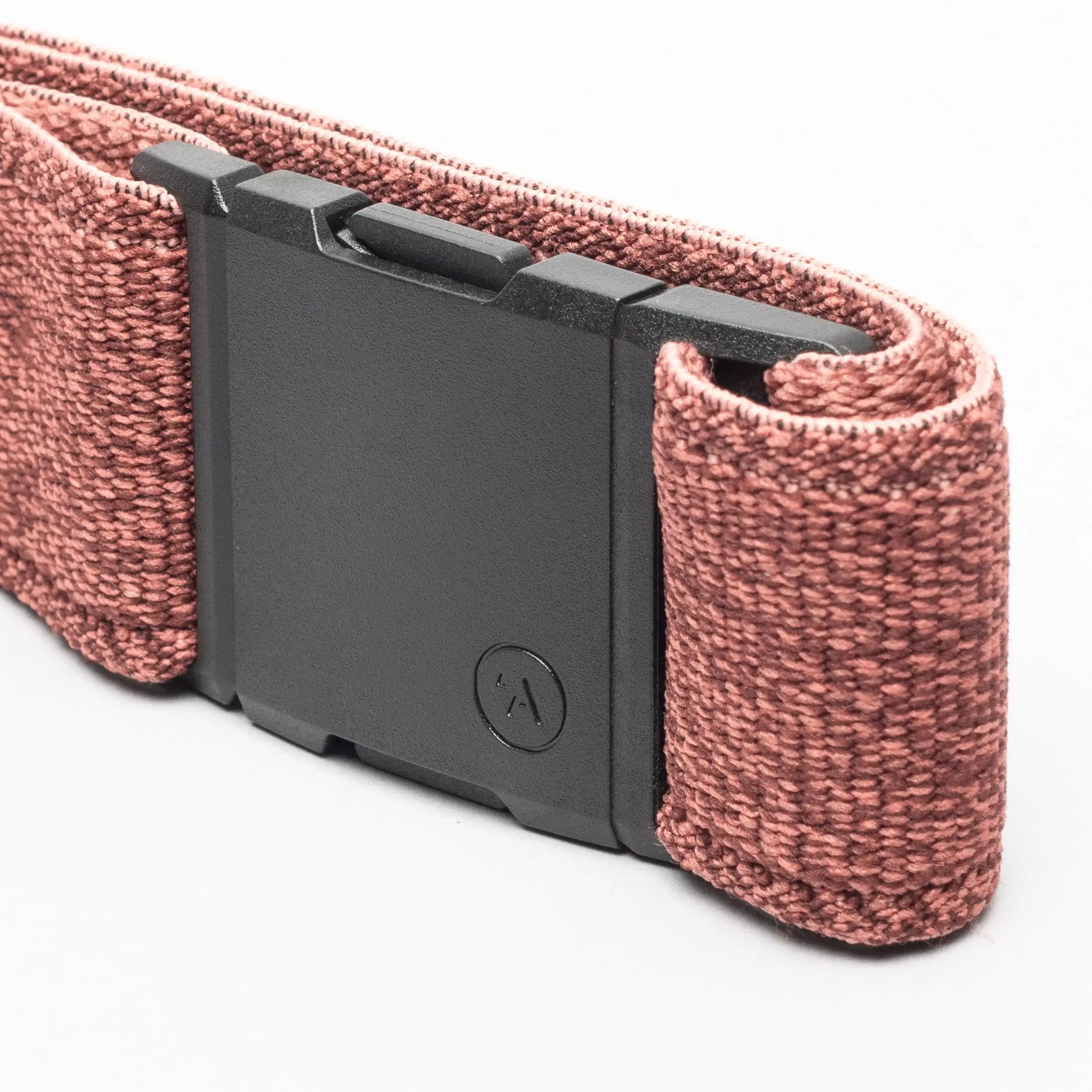 A close-up of the Atlas belt by Arcade Belts, featuring pink stretch woven fabric and a rectangular black buckle, shown against a white background.
