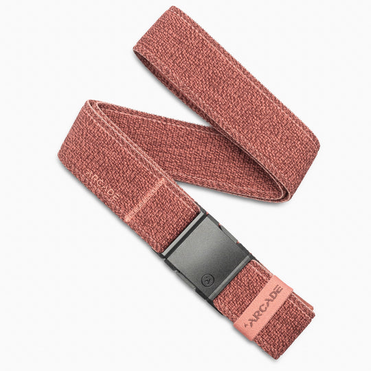 The Atlas by Arcade Belts is a reddish-brown stretch webbing belt with a black rectangular buckle, branded near the buckle and on a fabric tag at the end. It’s displayed in a loose loop on a white background.