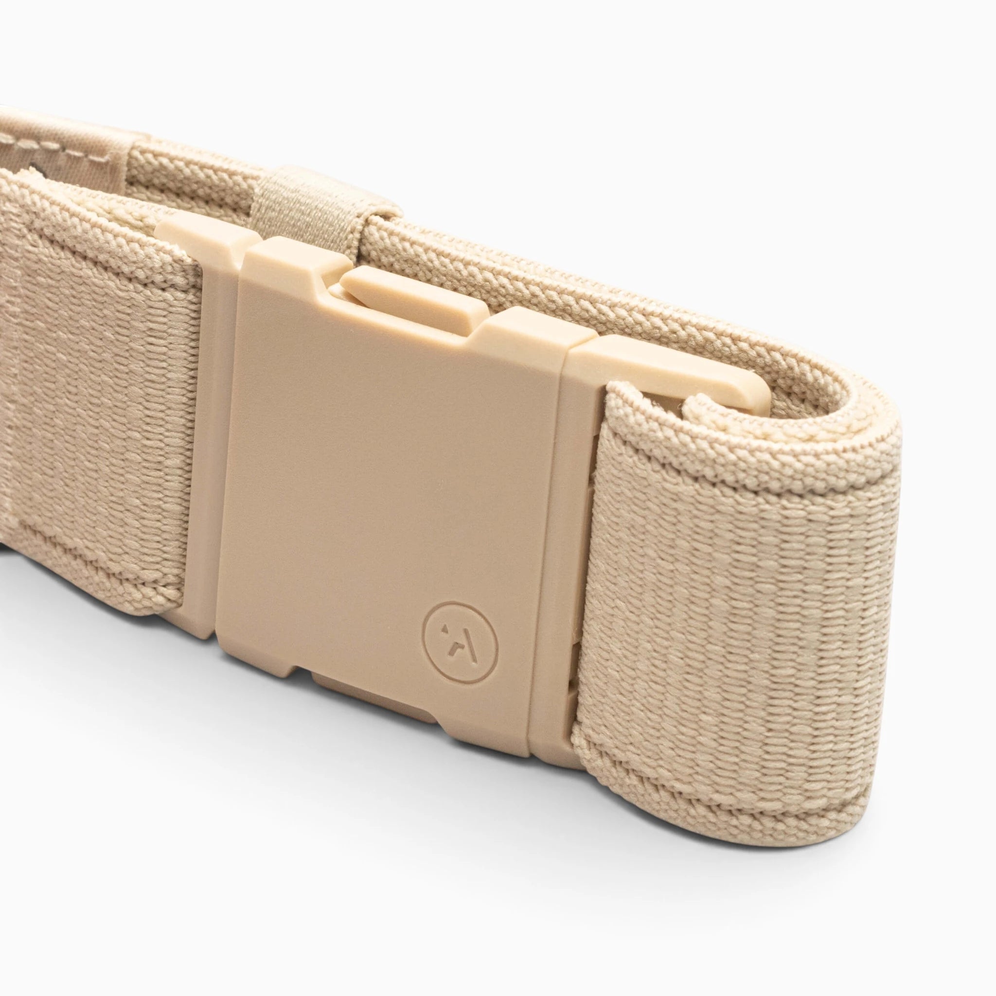 Atlas belt by Arcade Belts in beige nylon, featuring a rectangular A2 buckle, shown coiled on a white background.