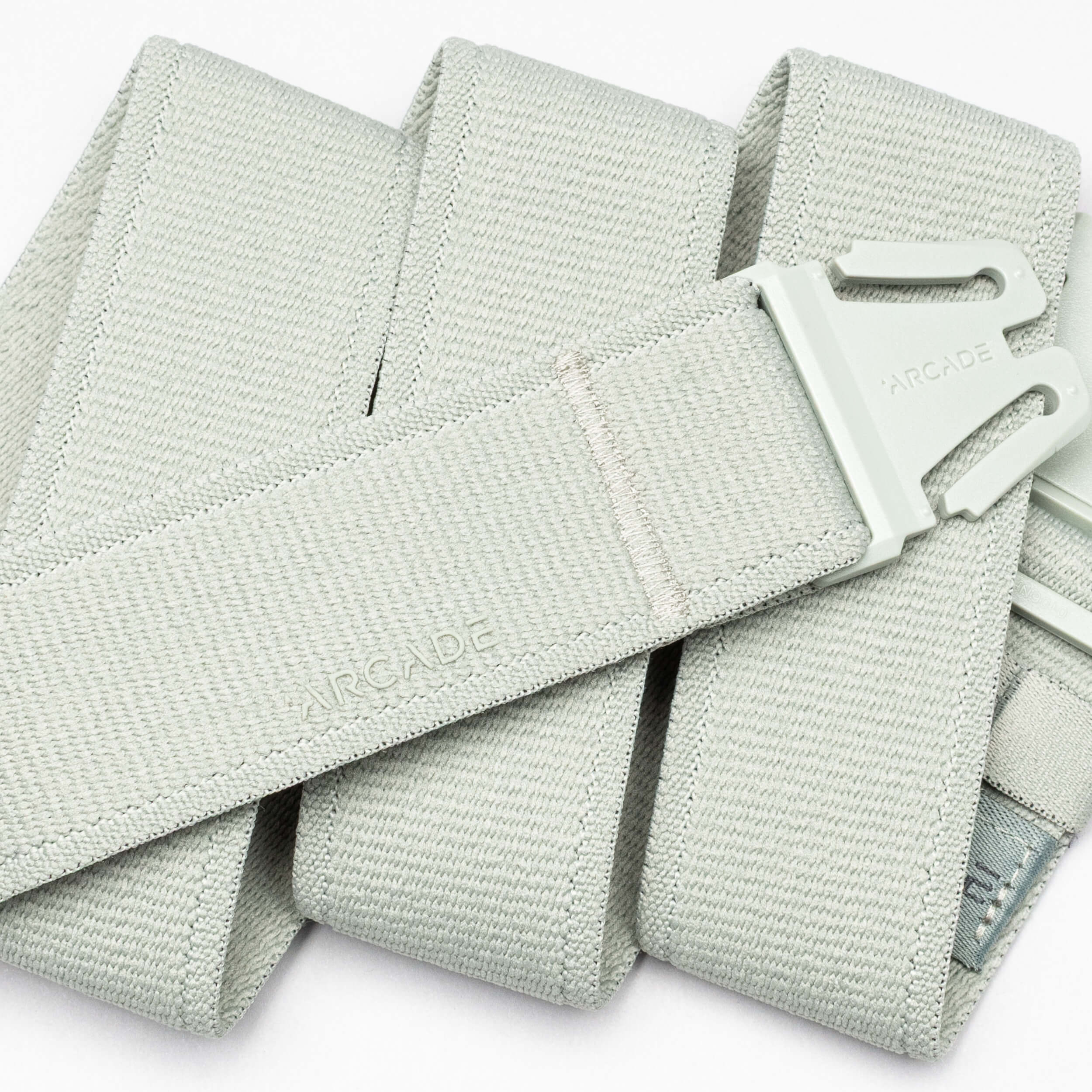 A close-up of the Atlas adventure belt in light gray by Arcade Belts, featuring an A2 buckle and the Arcade logo embossed on both the buckle and the belt.