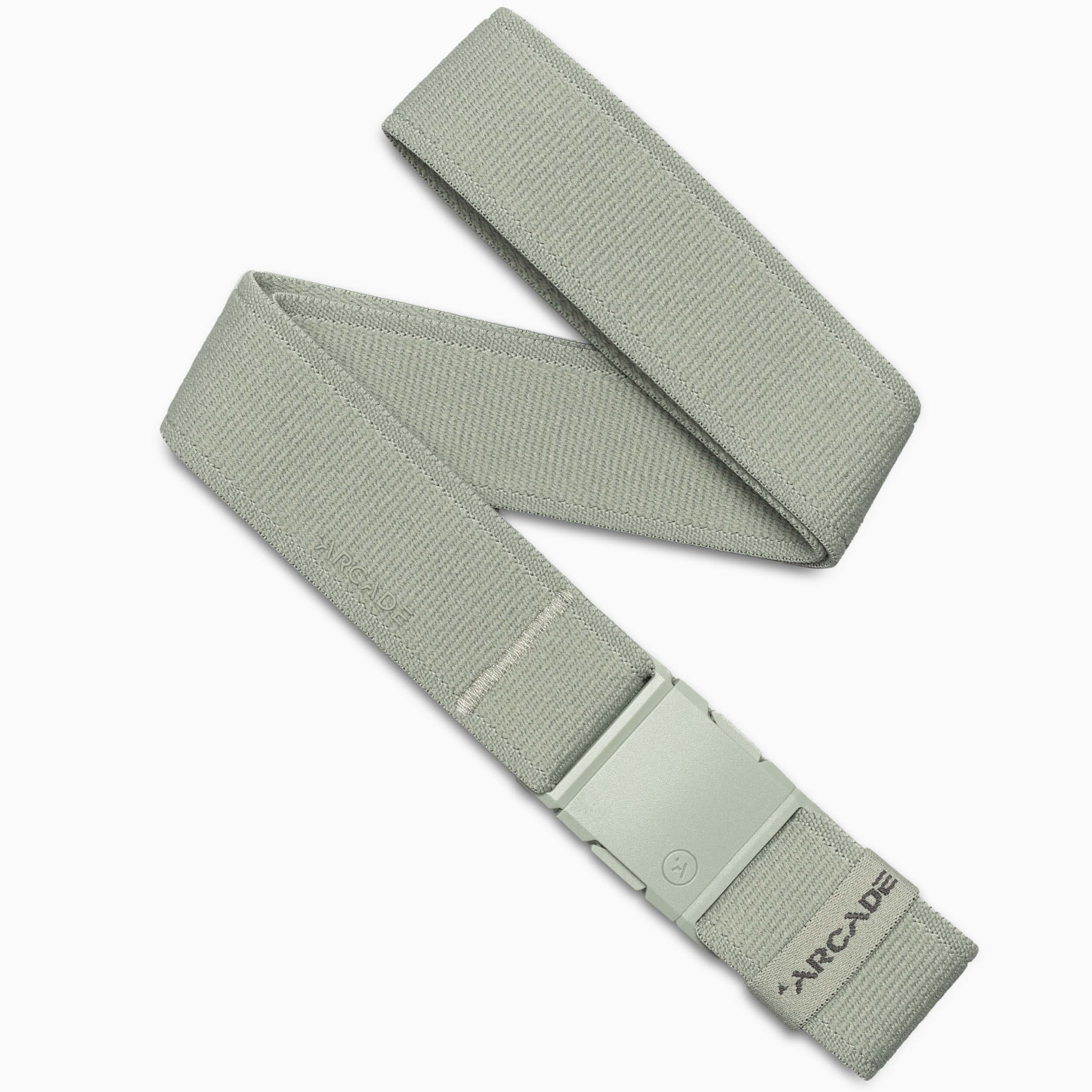 The Atlas by Arcade Belts is a light gray performance stretch belt with a matching A2 buckle, arranged in a loose zigzag. Near the end of this versatile adventure belt, “ARCADE” is printed.