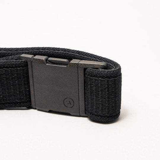 A close-up of the Arcade Belts Atlas low profile belt, featuring stretch webbing and a rectangular black plastic buckle, displayed against a plain white background.