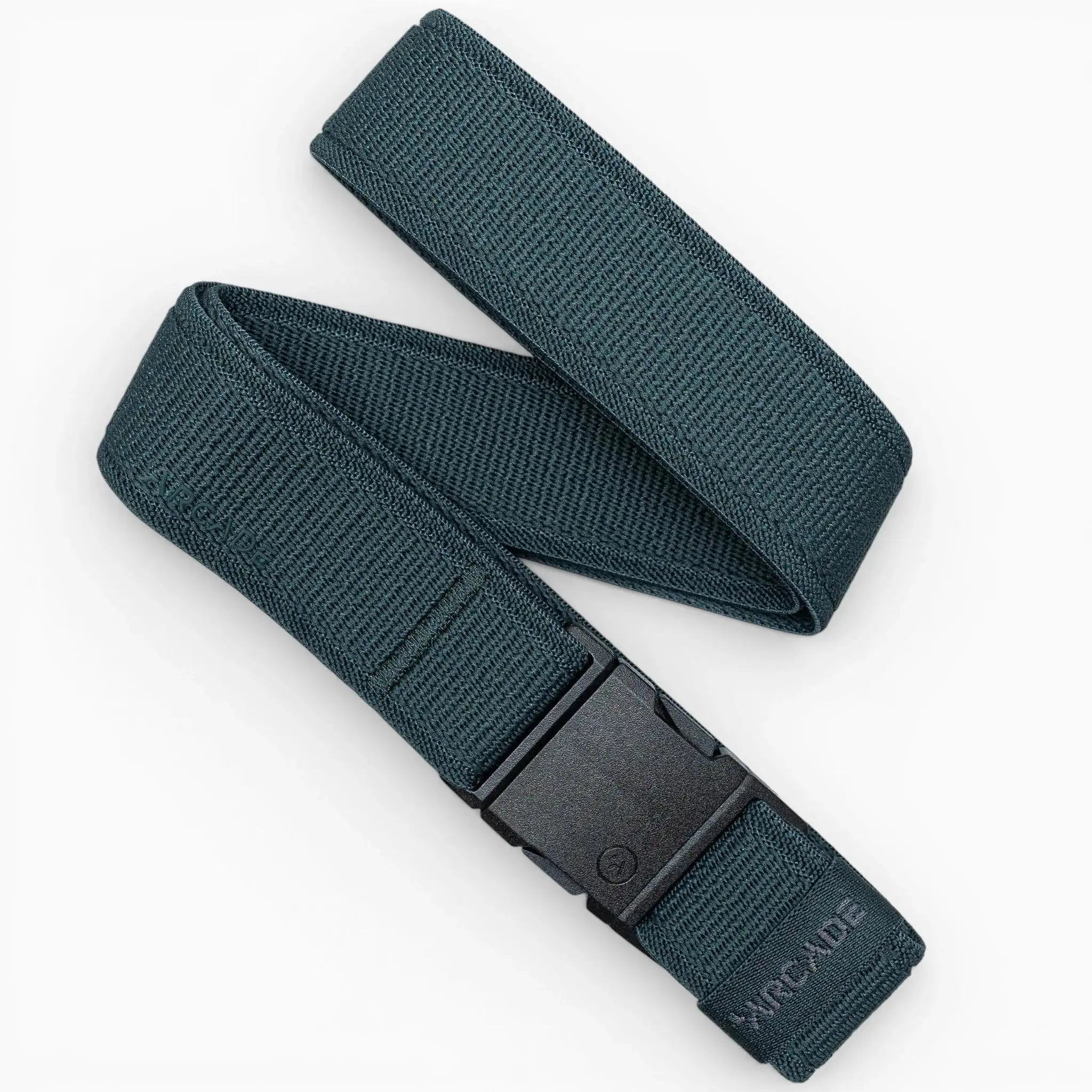 A dark green Atlas belt from Arcade Belts features elastic stretch fabric, a black plastic buckle, and ARCADE embossed near one end. It is displayed in a loose zigzag shape on a white background.