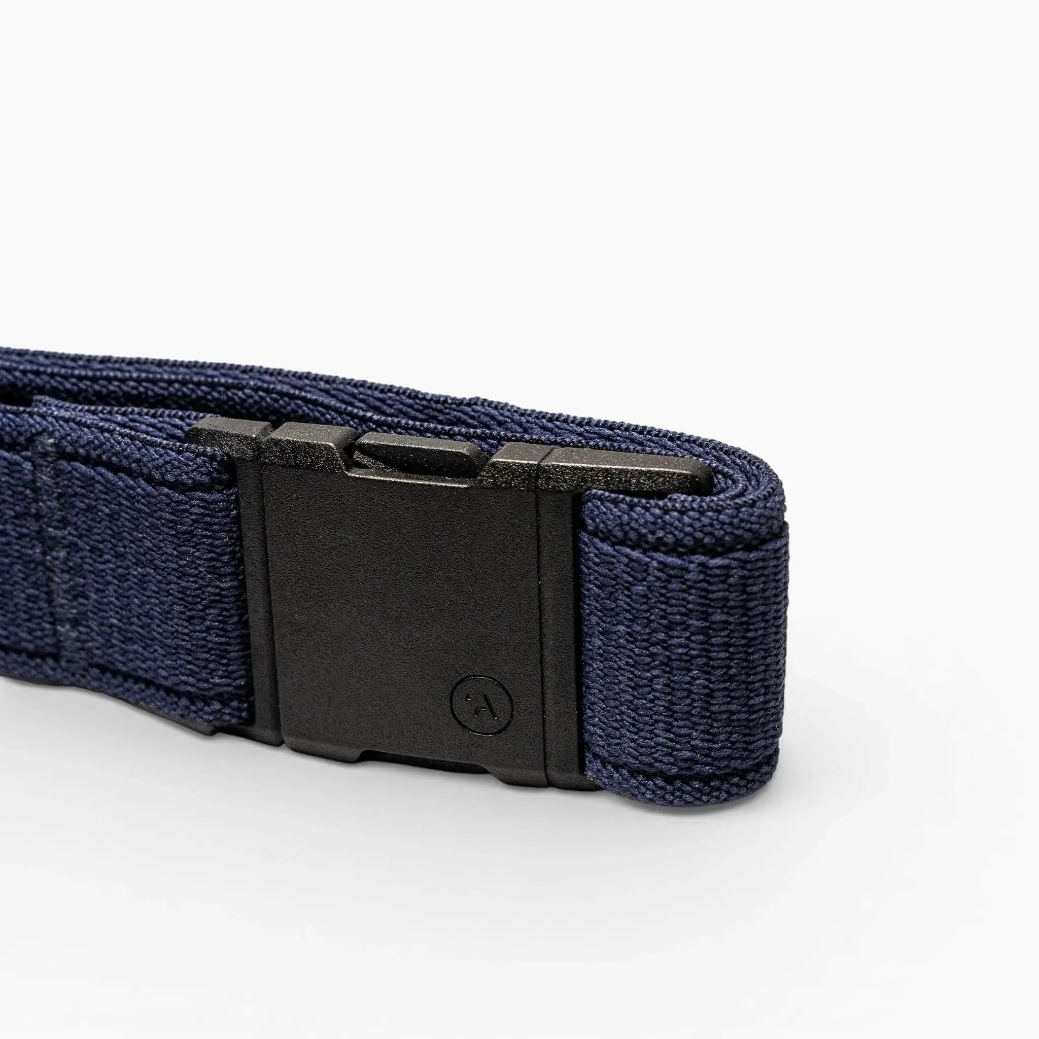 A close-up of the Atlas belt by Arcade Belts, featuring a navy blue elastic strap and a rectangular black plastic buckle, set against a plain light background.