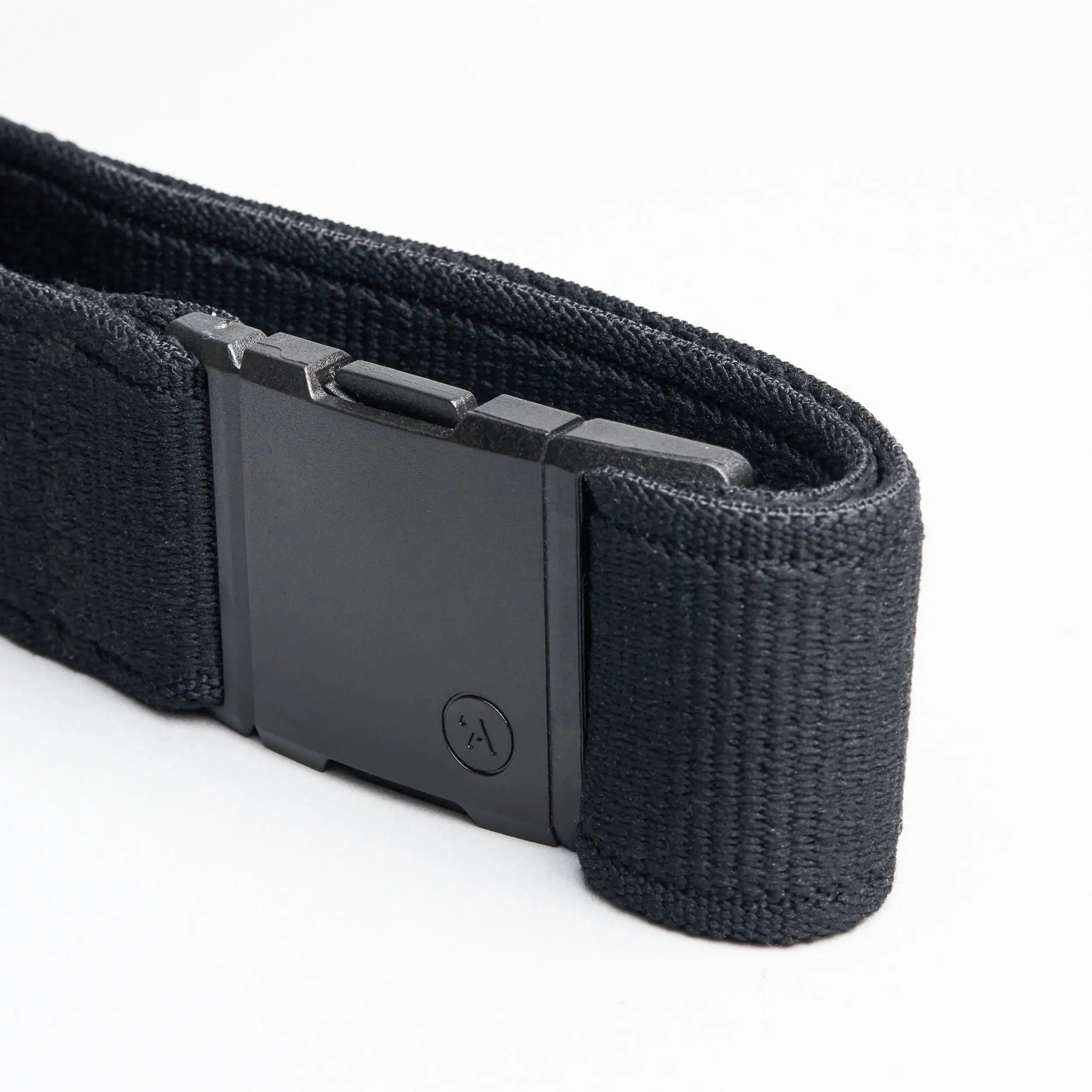 The Atlas by Arcade Belts is a black fabric belt with a rectangular matte black plastic buckle, shown on a white background—ideal for travelers seeking comfort.