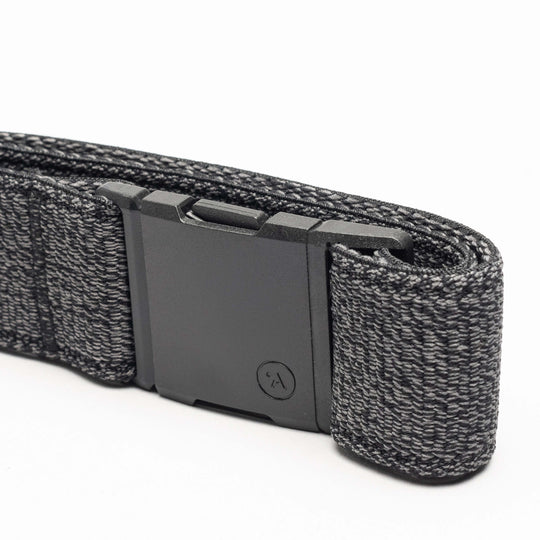A close-up of the Atlas elastic stretch belt by Arcade Belts in dark gray, featuring a rectangular black plastic buckle.