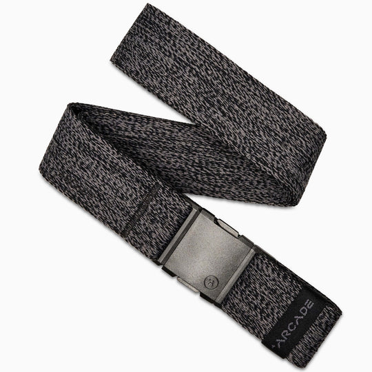 The Atlas belt by Arcade Belts is a gray and black woven elastic stretch belt with a rectangular gray plastic buckle and a black tag displaying the Arcade logo at the end.