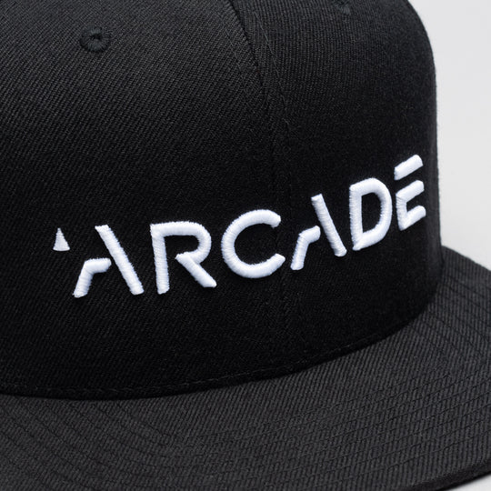 The Arcade Structured Hat by Arcade Belts features bold white ARCADE embroidery on a black cap—ideal for fans of streetwear and the brand.