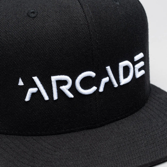 The Arcade Structured Hat by Arcade Belts features bold white ARCADE embroidery on a black cap—ideal for fans of streetwear and the brand.