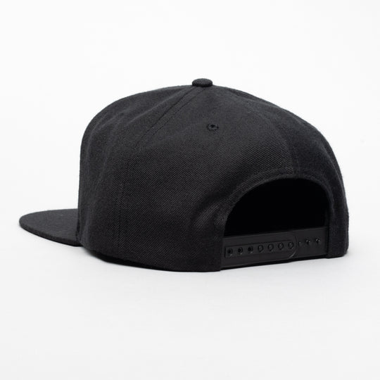 The Arcade Structured Hat from Arcade Belts is a black snapback cap displayed from the back on a white background, featuring an adjustable plastic buckle strap similar to those on Arcade Belts.