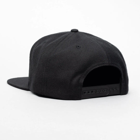 The Arcade Structured Hat from Arcade Belts is a black snapback cap displayed from the back on a white background, featuring an adjustable plastic buckle strap similar to those on Arcade Belts.