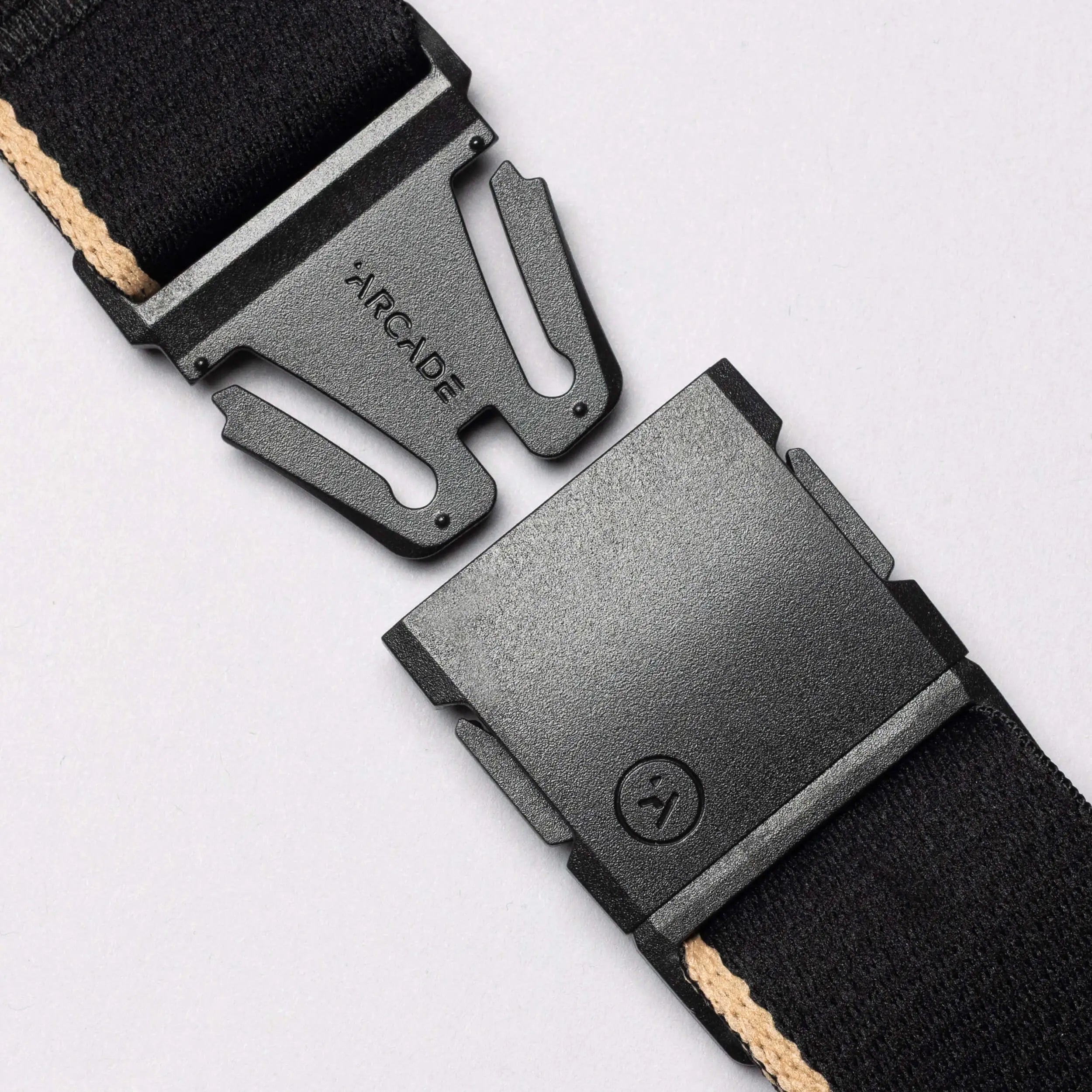 Close-up of the Arcade Belts Blackwood belt with an A2 buckle. This black belt features a beige stripe and a sleek, modern buckle design, representing the signature Arcade classic style.