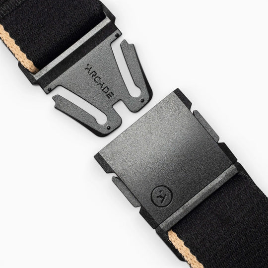 Close-up of the Arcade Belts Blackwood belt with an A2 buckle. This black belt features a beige stripe and a sleek, modern buckle design, representing the signature Arcade classic style.