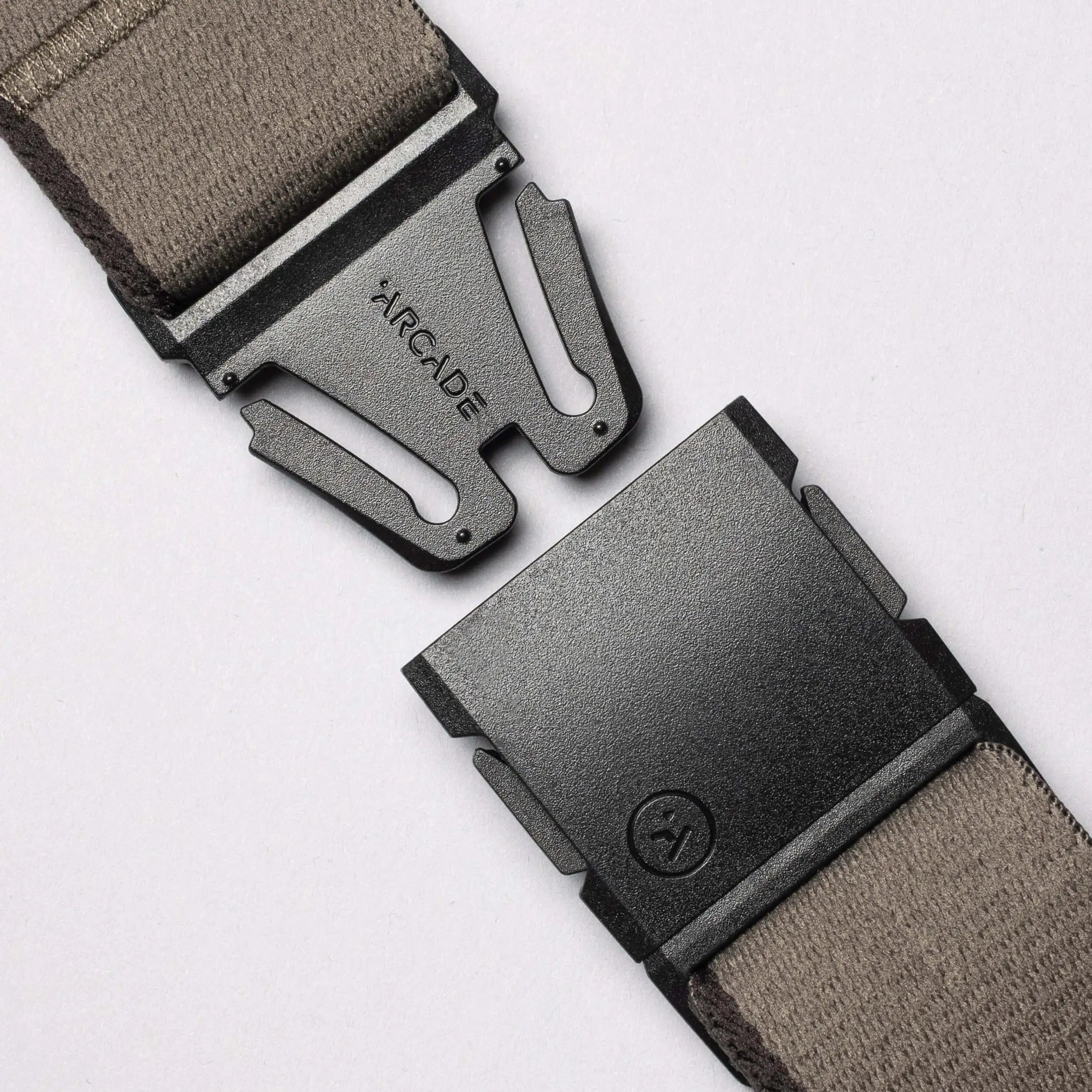 Close-up of the Arcade Belts Blackwood belt, featuring a gray fabric strap and a black metal A2 buckle engraved with "ARCADE," shown open on a light background.