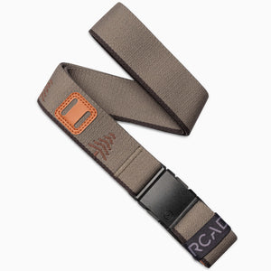 The Arcade Belts Blackwood in Dunes Bay is a brown fabric belt featuring an A2 buckle, tan leather accent, stitched pattern, and a black and purple tag—designed for stylish explorers.