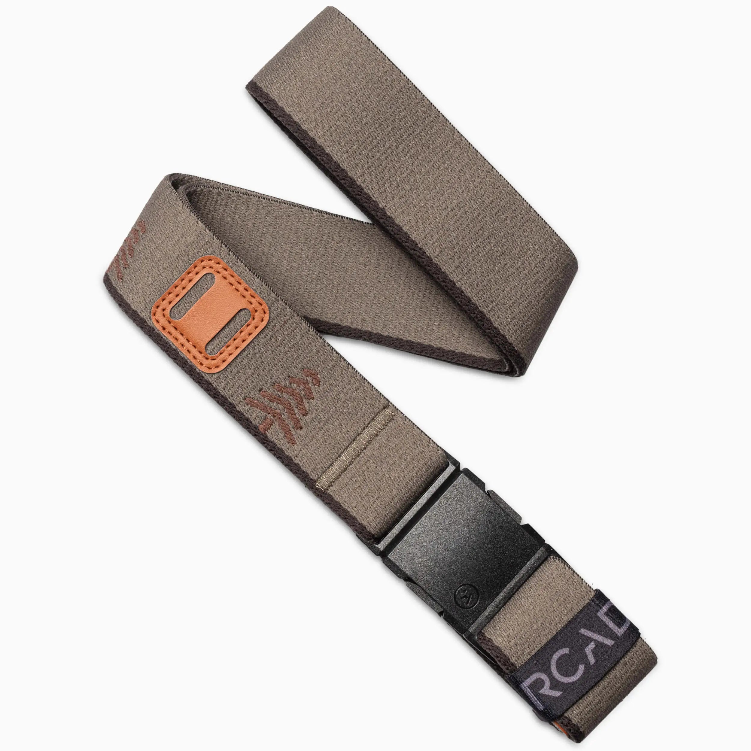 The Arcade Belts Blackwood Kit features a brown stretch belt with a black plastic buckle, tan leather accent, visible stitching, and a black label with white text at the end for all-day comfort.