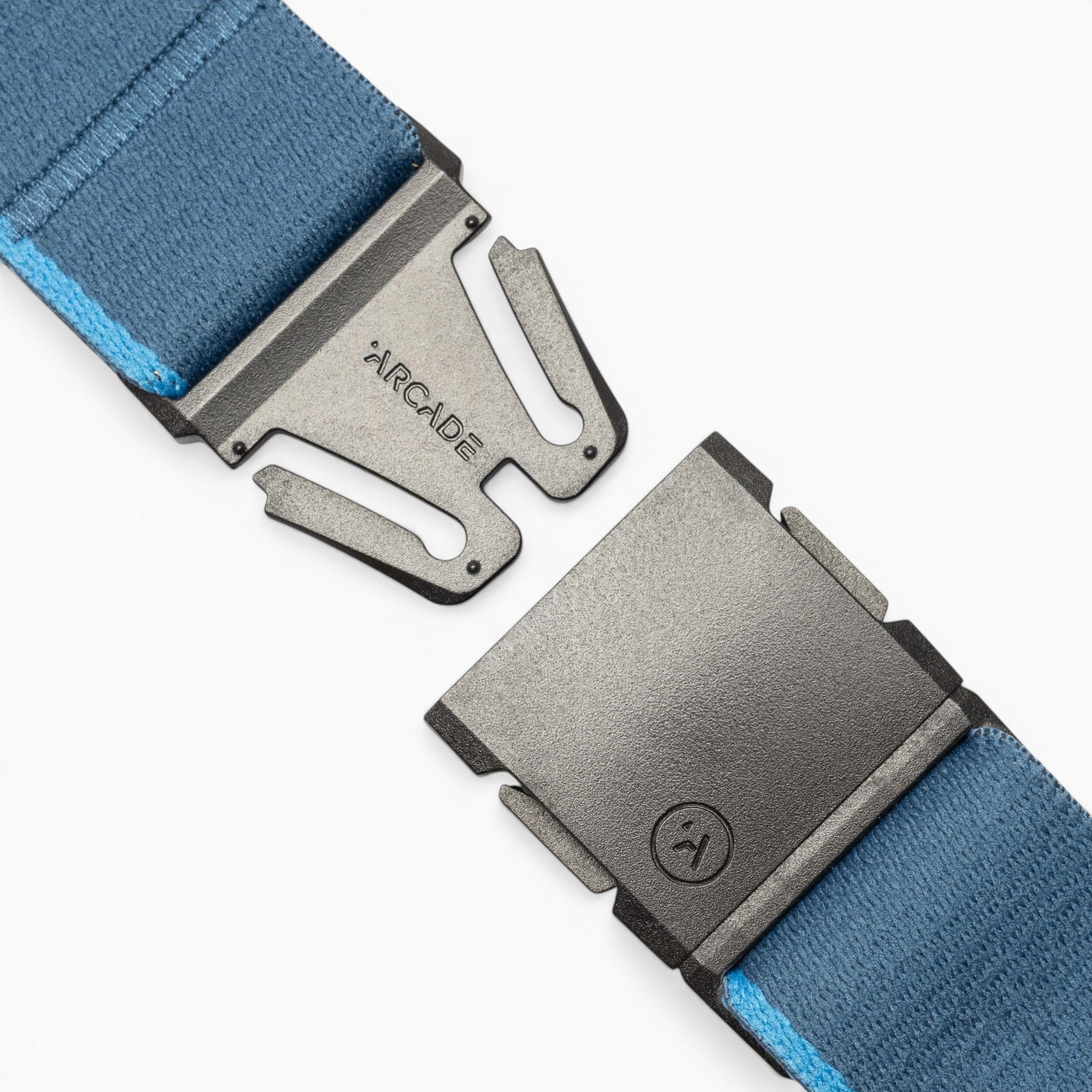 Close-up of the Arcade Belts Blackwood, a blue fabric belt featuring a metallic black A2 buckle. The buckle displays “ARCADE” engraved on one side and a small logo on the other, highlighting the signature Blackwood design. The fabric includes a light blue edge and is shown partially unclasped.