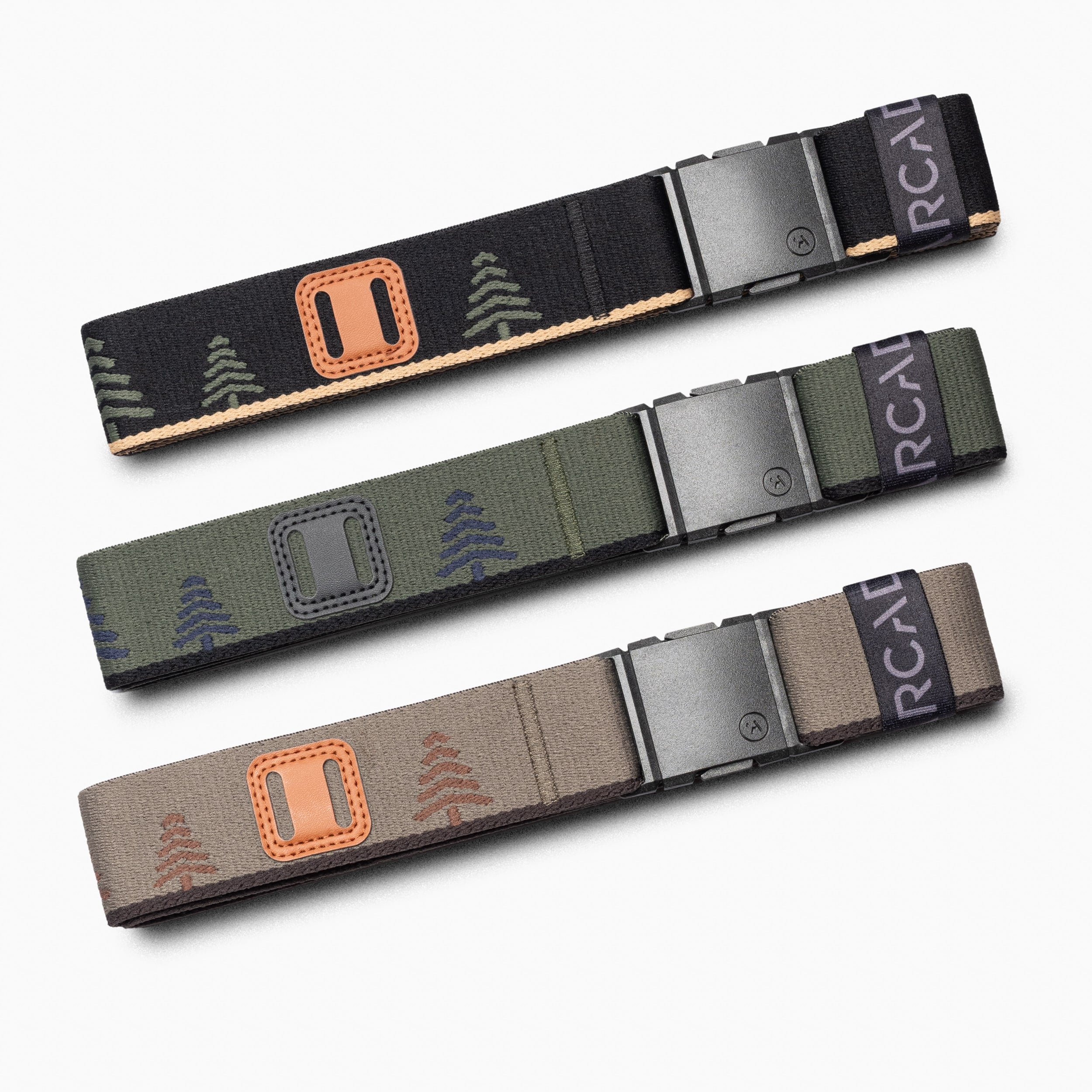 The Arcade Belts Blackwood Kit features three stretch belts with metal buckles, each displaying a tree pattern in black, green, and beige—delivering all-day comfort and style for any wardrobe.