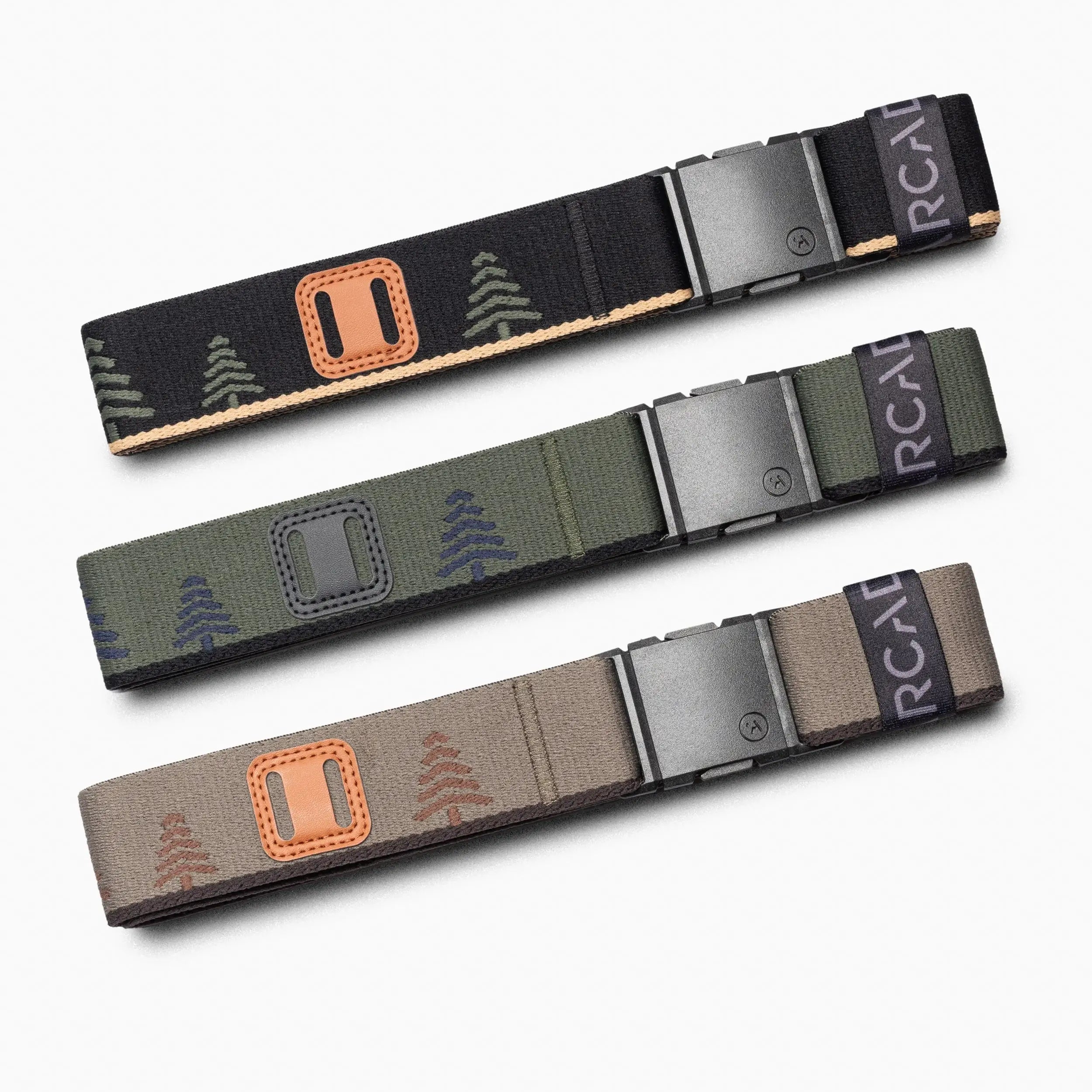 The Arcade Belts Blackwood Kit features three stretch belts with metal buckles, each displaying a tree pattern in black, green, and beige—delivering all-day comfort and style for any wardrobe.