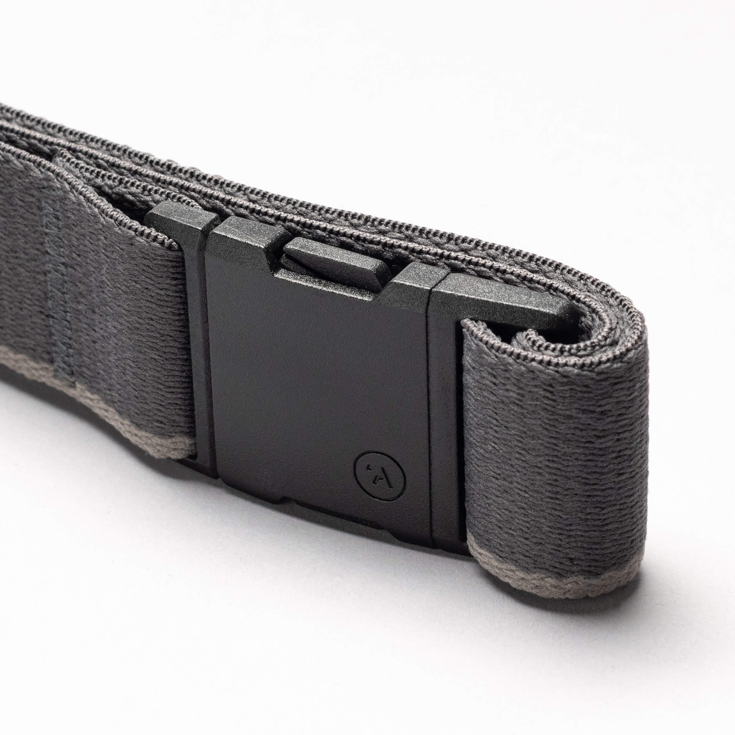 A close-up of the Arcade Belts Blackwood, a gray fabric belt with a black A2 buckle, photographed against a white background. The partially rolled design highlights its texture and stitching.
