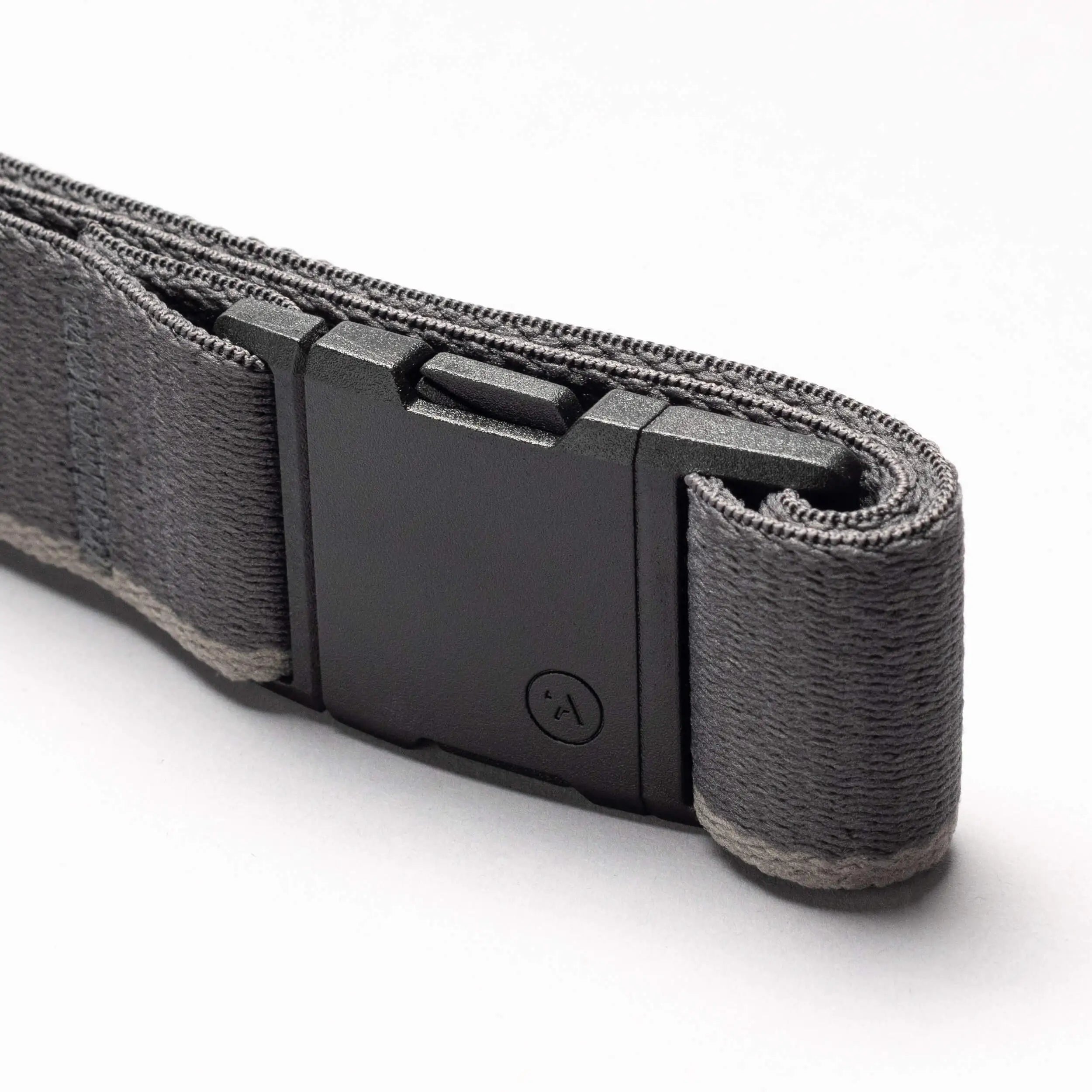 A close-up of the Arcade Belts Blackwood, a gray fabric belt with a black rectangular A2 buckle, partially coiled on a white background.