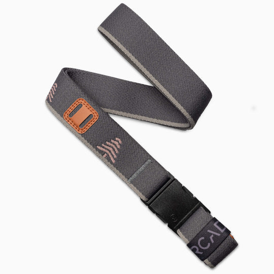 The Arcade Belts Blackwood belt in Charcoal Blush features a sleek buckle, light brown stitching, and subtle pink and white geometric patterns—an ideal accessory for stylish explorers seeking effortless flair.