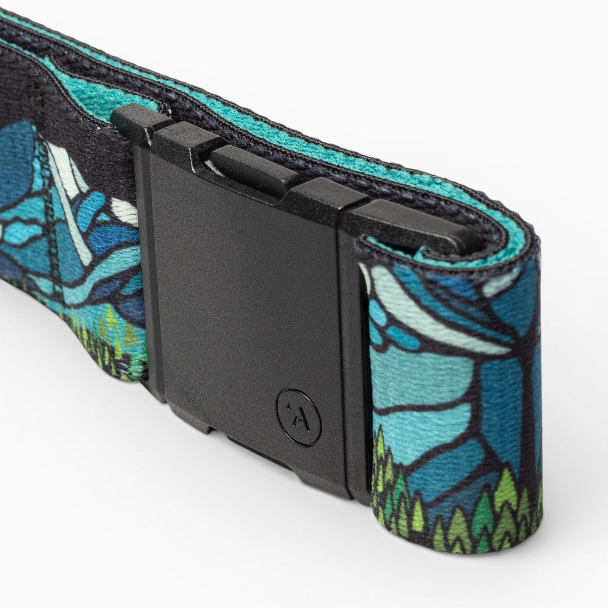 A close-up of the Arcade Belts Broken Arrow Adventure Belt, featuring a black rectangular buckle and a blue-green stained glass-inspired pattern—perfect for trail running or showing your Broken Arrow Skyrace spirit.