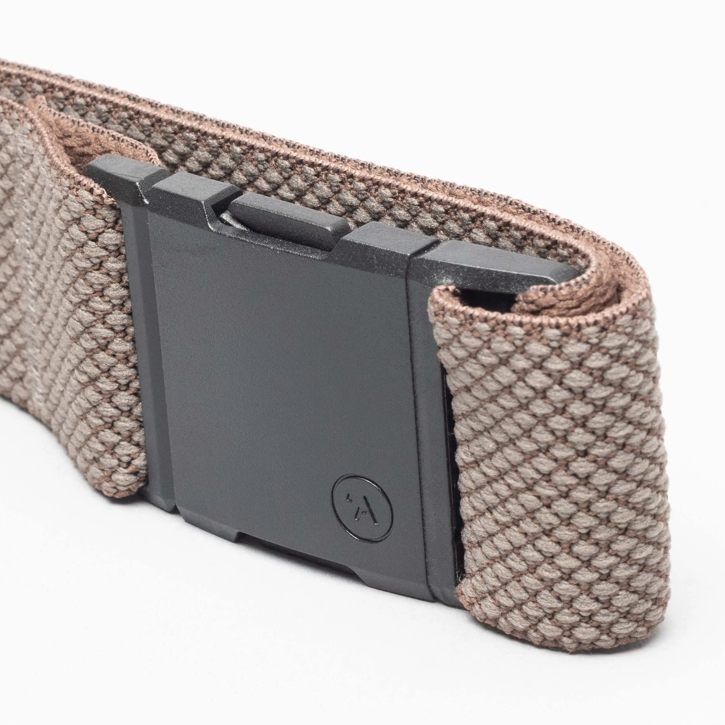 A close-up of the Arcade Belts Carry, featuring a woven brown fabric band with a unique weave and a rectangular black plastic clasp, displayed against a white background.