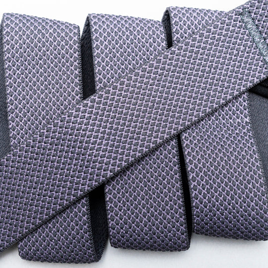 Close-up of four textured, purple Carry neckties by Arcade Belts with a unique weave, arranged parallel and one similar tie placed diagonally across them on a light background for a layered effect.