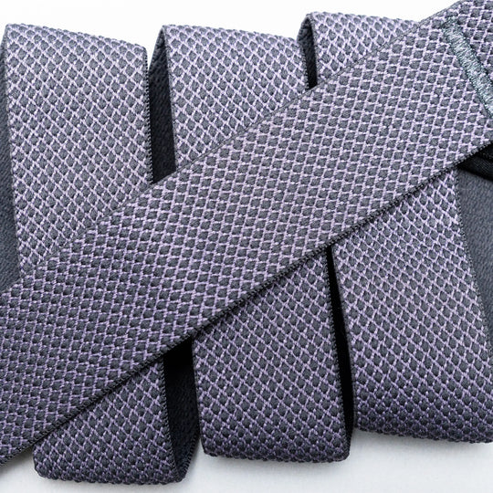 Close-up of four textured, purple Carry neckties by Arcade Belts with a unique weave, arranged parallel and one similar tie placed diagonally across them on a light background for a layered effect.